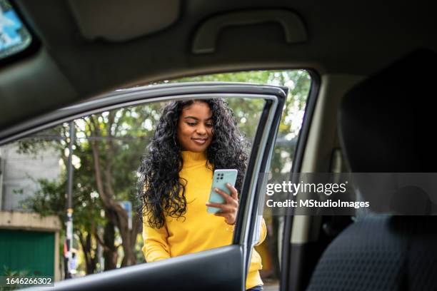 getting a taxi with mobie app. - inside car door stock pictures, royalty-free photos & images