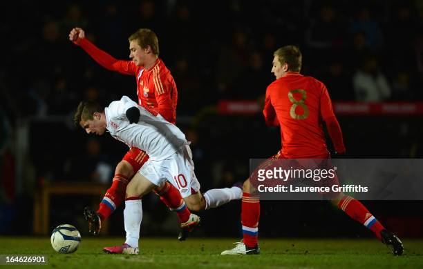 Dmitriy Barinov of Russia battles with Daniel Crowley of England during the UEFA European Under-17 Championship Elite Round match between England...