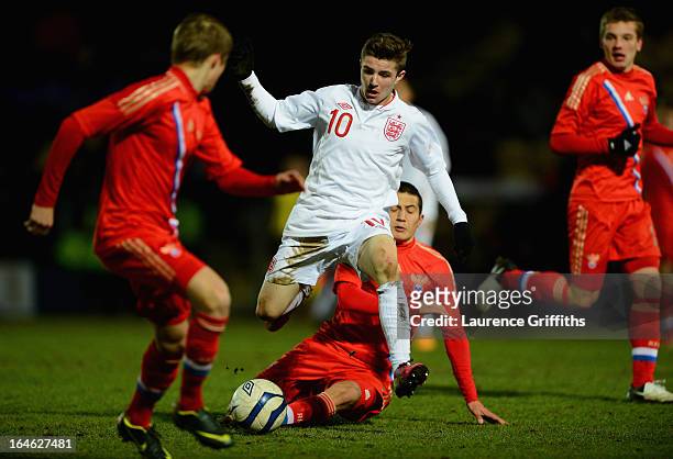 Daniel Crowley of England battles with Dzhamaldin Khodzhaniiazov of Russia during the UEFA European Under-17 Championship Elite Round match between...