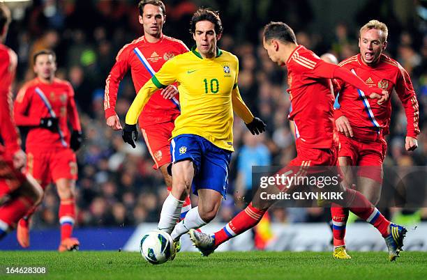 Brazil's midfielder Kaka passes the ball as Russia's defender Sergei Ignashevich stretches to block during the international friendly football match...