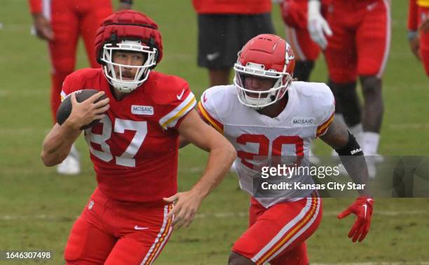 Kansas City Chiefs tight end Travis Kelce runs with the ball as safety Justin Reid pursues during training camp at Missouri Western State University...