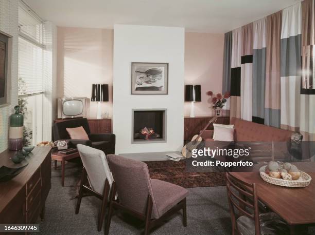 Interior view of a contemporary living room, it contains a sofa, chairs and an armchair, a side table with telephone, sideboard, dining table,...