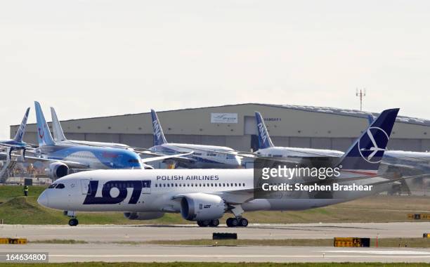 Polish Airlines Boeing 787 Dreamliner with a redesigned lithium ion battery taxis in front of a row of 787 airliners after landing during a test...