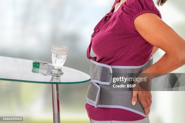 back pain - medical belt - orthopedic corset stock pictures, royalty-free photos & images