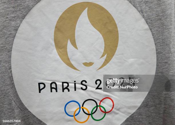 Paris Olympics 2024 logo on the one of the Paris Olympics 2024 official t-shirts on display in a shop at Paris Charles de Gaulle Airport, on August...