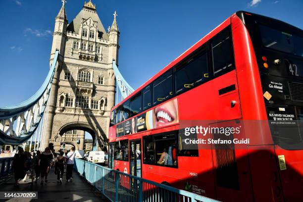 General view of London bus passes under Tower Bridge on August 22, 2023 in London, England. London is the capital of England, many of the...