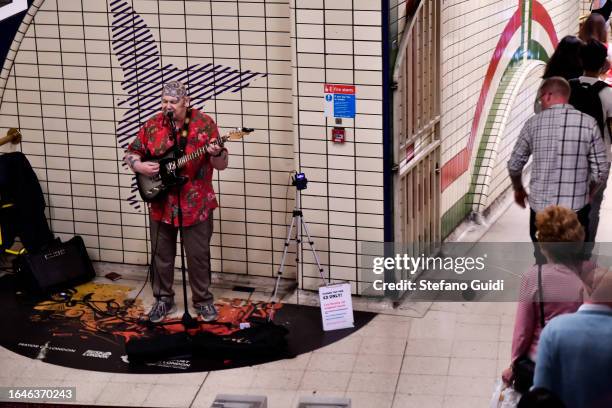 Street musician plays inside the tube station on August 22, 2023 in London, England. London is the capital of England, many of the inhabitants,...