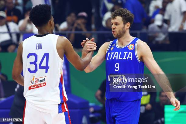 Nicolo Melli of Italy is congratulated by AJ Edu of the Philippines after the FIBA Basketball World Cup Group A victory at Araneta Coliseum on August...