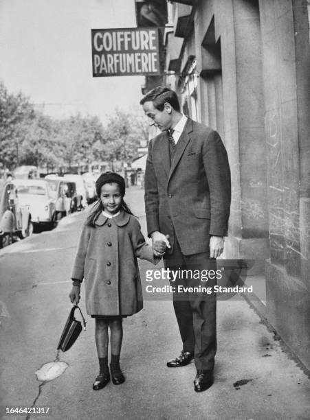 French fashion designer Marc Bohan, newly-appointed director of Christian Dior, pictured with daughter Marie-Anne, November 1960.