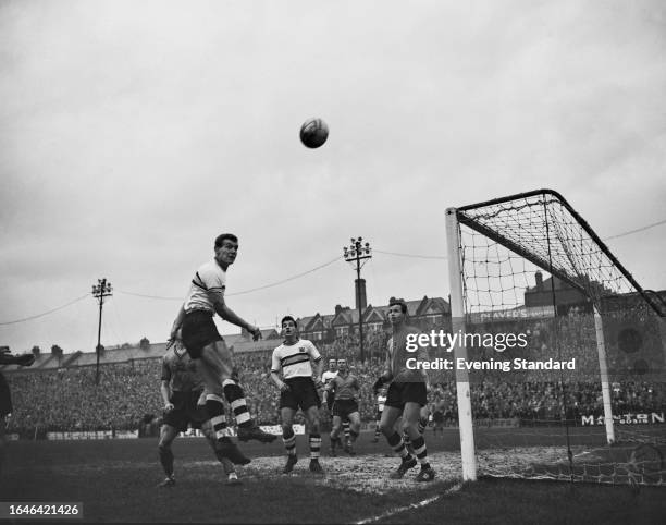 Watford's Freddie Bunce heads the ball past goal as Crystal Palace goalkeeper Vic Rouse and other players including defenders Terry Long and Gwyn...