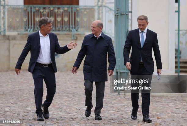 German Chancellor Olaf Scholz , Economy and Climate Action Minister Robert Habeck and Finance Minister Christian Lindner emerge to give statements to...