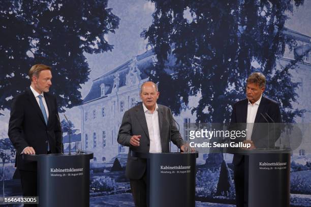 German Chancellor Olaf Scholz , Economy and Climate Action Minister Robert Habeck and Finance Minister Christian Lindner give statements to the media...