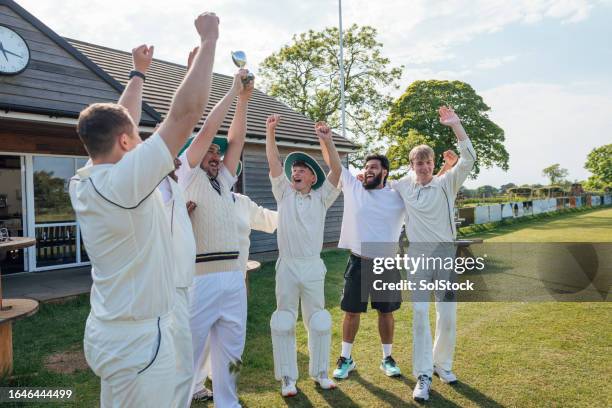 team celebrating their win - people holding trophy stock pictures, royalty-free photos & images