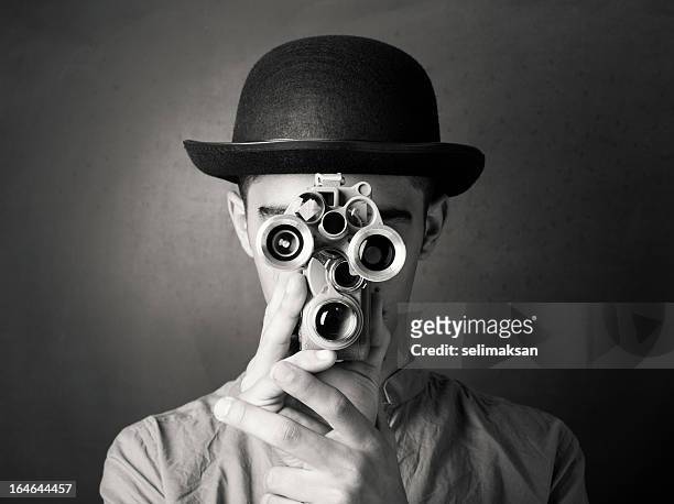 young man in old fashioned style filming via antique camera - black and white stock pictures, royalty-free photos & images