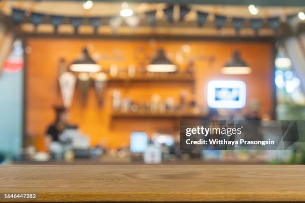 empty wooden table top with blur coffee shop or restaurant interior background - defocused stock pictures, royalty-free photos & images