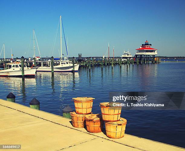 crab baskets at the choptank river lighthouse - cambridge maryland lighthouse stock pictures, royalty-free photos & images