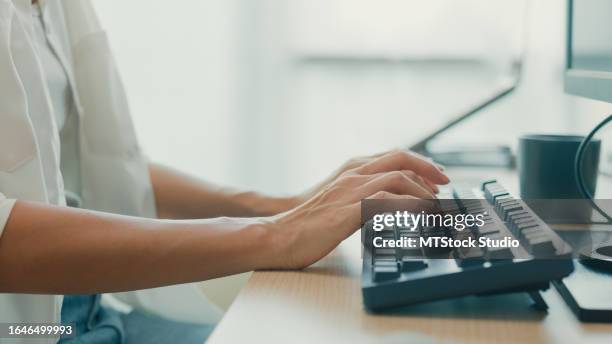 closeup young asian woman software developers using computer to write code sitting at desk with multiple screens work at office. programmer development. - application programming interface stock pictures, royalty-free photos & images