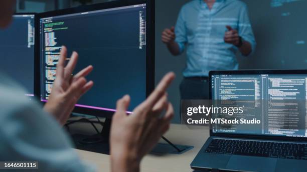 nahaufnahme junger asiatischer mann softwareentwickler mentor führungsmanager im gespräch mit führungsteam analysiert quellcode im büro in der nacht. entwicklung von programmierern. - python-programmiersprache stock-fotos und bilder