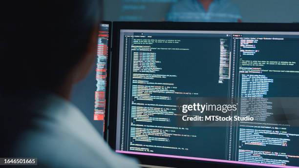 closeup young asian man software developers mentor leader manager talking to executive team analyzing source code in office at night. programmer development. - coding stock pictures, royalty-free photos & images
