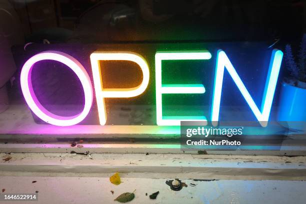 Neon sign 'OPEN' seen in a shop window in Edmonton Center, on August 23 in Edmonton, Alberta, Canada.