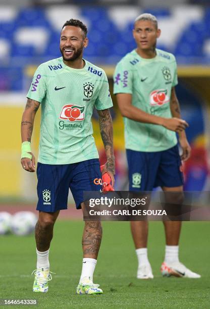 Brazil's forwards Neymar and Richarlison are seen during a training session at the Mangueirao stadium in Belem, Para State, Brazil, on September 5...