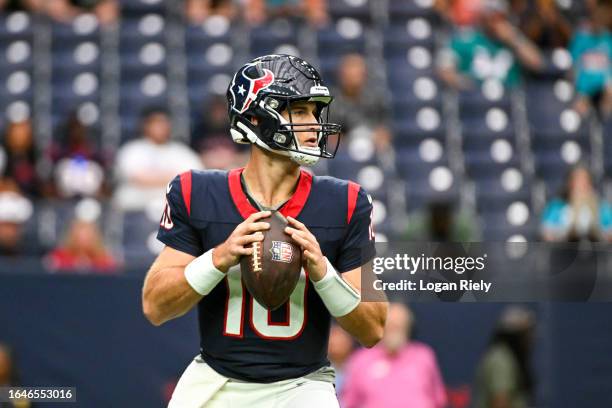 Davis Mills of the Houston Texans looks to pass in the second half during the preseason game against the Miami Dolphins at NRG Stadium on August 19,...