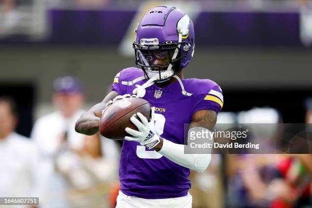 Jordan Addison of the Minnesota Vikings warms up prior to the start of a preseason game against the Arizona Cardinals at U.S. Bank Stadium on August...