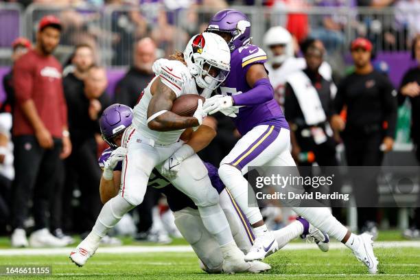 Corey Clement of the Arizona Cardinals is tackled by Wilson Huber and William Kwenkeu of the Minnesota Vikings in the second half of a preseason game...