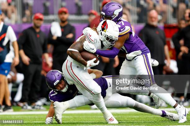 Corey Clement of the Arizona Cardinals is tackled by Wilson Huber and William Kwenkeu of the Minnesota Vikings in the second half of a preseason game...
