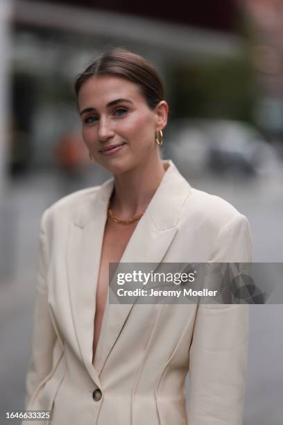 Marie Danker seen wearing Carolina Lemke black sunglasses, Missoma gold jewelry / earrings and necklace, Zara white cream suit / blazer jacket, on...