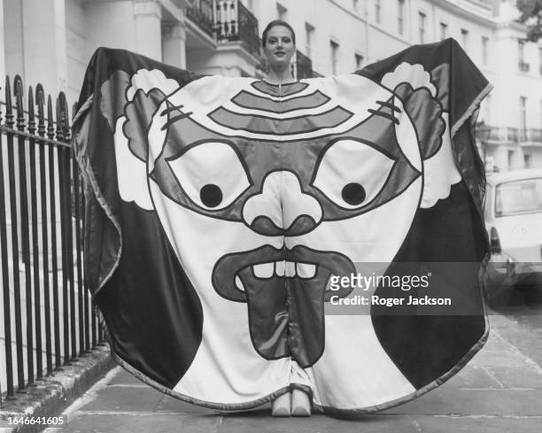 English artist, journalist and political activist, Caroline Coon, modeling 'Tongue', a crepe and satin jumpsuit by Japanese fashion designer, Kansai...