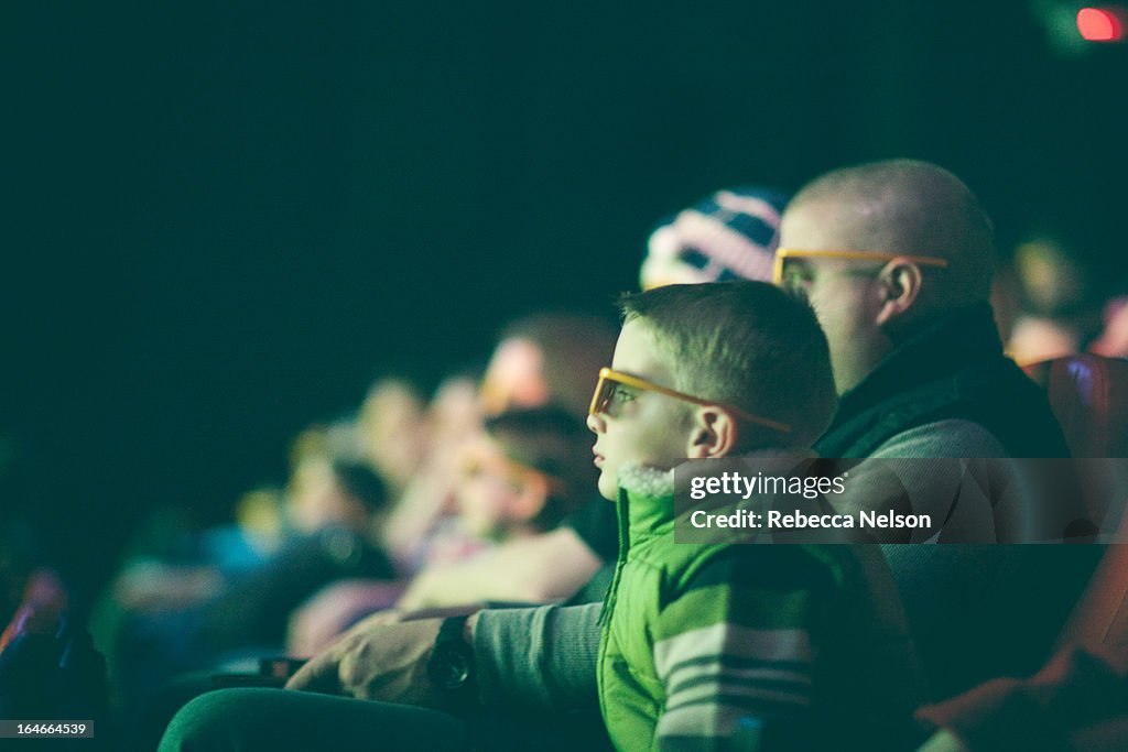 Boy and his dad watching a 3D movie
