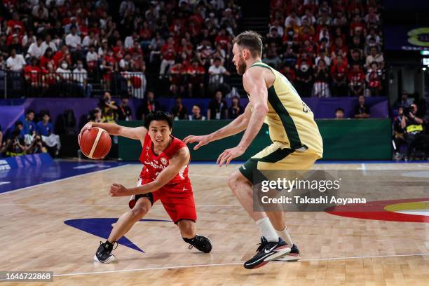 Yuki Togashi of Japan drives to the basket against Nick Kay of Australia during the FIBA Basketball World Cup Group E game between Australia and...