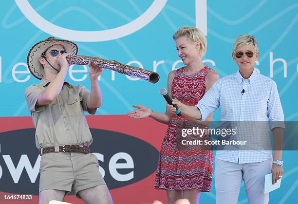 Television personality Ellen DeGeneres and her wife Portia de Rossi watch as executive producer Andy Lassner plays a didgeridoo on stage during the...