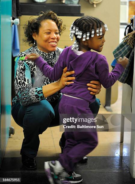 Dr. Patricia Bell-McDuffie, left, gets a hug from Mariah Venable after Venable was seen at the clinic, March 21 in Baltimore, Maryland. McDuffie...