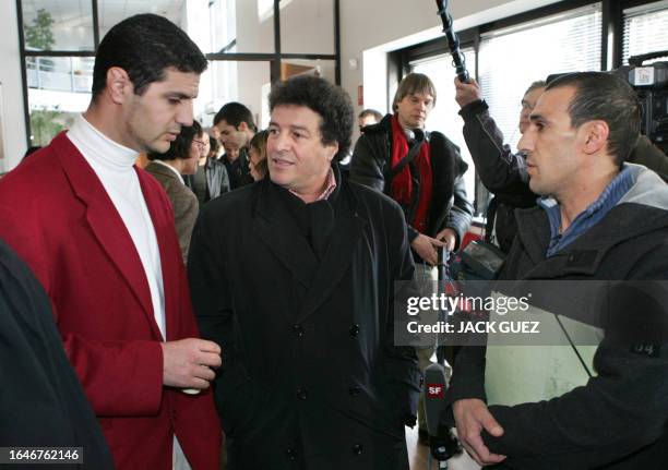 Mouloud Aounit , the secretary general of the French anti-racist NGO MRAP chats with the two Paris airport workers who had been stripped of security...