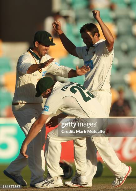 Ricky Ponting of the Tigers is picked up by teammates James Faulkner and Ben Hilfenhaus in celebration of victory in the Sheffield Shield final...