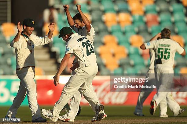 Ricky Ponting of the Tigers celebrates with teammates James Faulkner and Ben Hilfenhaus after victory in the Sheffield Shield final between the...