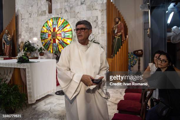 Don Maurizio Patriciello parish priest in the church of San Paolo Apostolo in the Green Park on August 29, 2023 in Naples, Italy. Two children of...