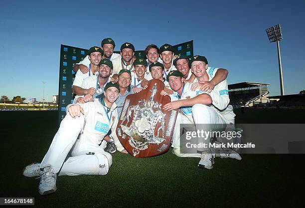 The Tigers pose with the Sheffield Shield trophy after winning the Sheffield Shield final between the Tasmania Tigers and the Queensland Bulls at...