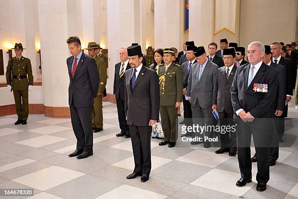 Sultan of Brunei Darussalam, His Majesty Hassanal Bolkiah and MP Chris Tremain look on during a wreath-laying ceremony at the National War Memorial...