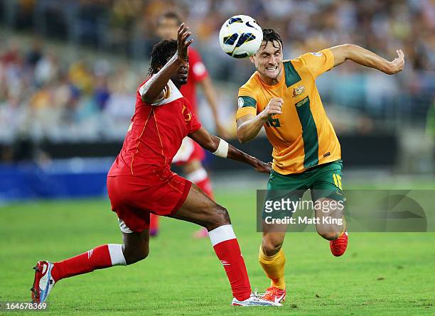 James Holland of the Socceroos is challenged by Ahmed Mubarak of Oman during the FIFA 2014 World Cup Qualifier match between the Australian Socceroos...