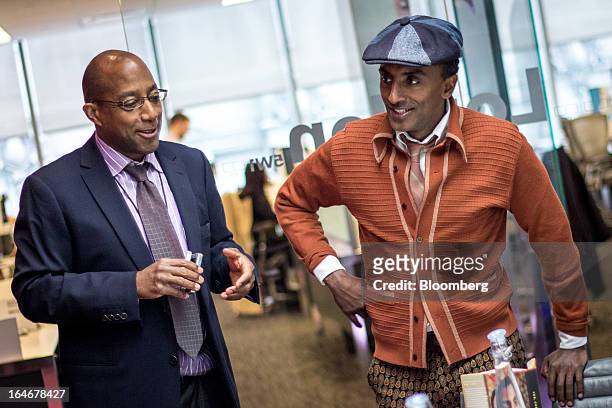 Patrick Cole, reporter for the arts and culture team at Bloomberg News, left, shares a laugh with Marcus Samuelsson, owner and chef of Red Rooster...