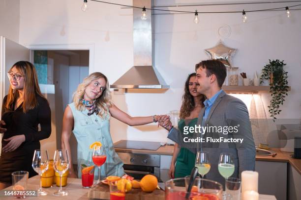 friends greeting each other while they arriving for a house party - punching glass stock pictures, royalty-free photos & images