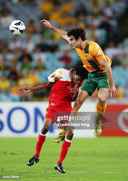 Mile Jedinak of the Socceroos jumps above Raed Saleh of Oman during the FIFA 2014 World Cup Qualifier match between the Australian Socceroos and Oman...