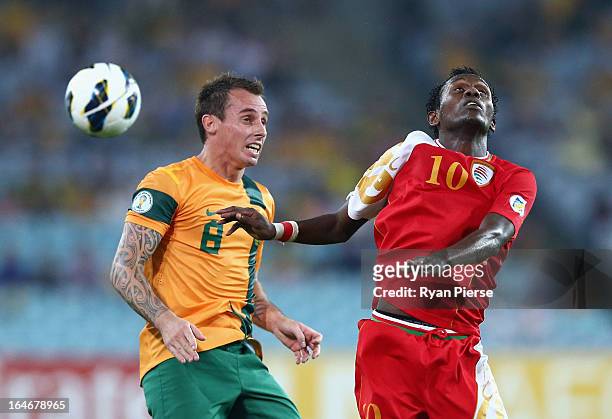 Luke Wilkshire of the Socceroos competes for the ball against Qasim Said of Oman during the FIFA 2014 World Cup Qualifier match between the...