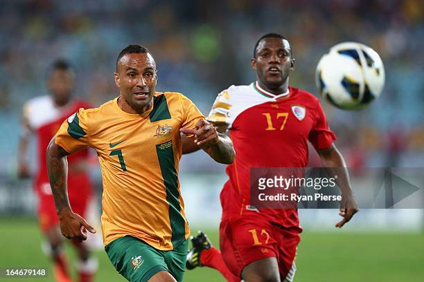 Archie Thompson of the Socceroos competes for the ball against Hassan al Gheilani of Oman during the FIFA 2014 World Cup Qualifier match between the...
