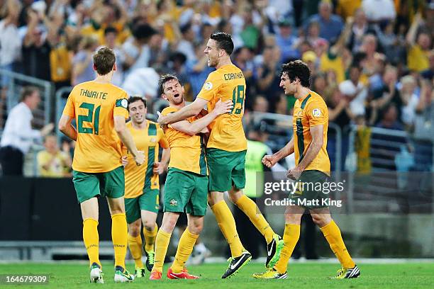 Brett Homan of the Socceroos celebrates with team mates after scoring a goal during the FIFA 2014 World Cup Qualifier match between the Australian...