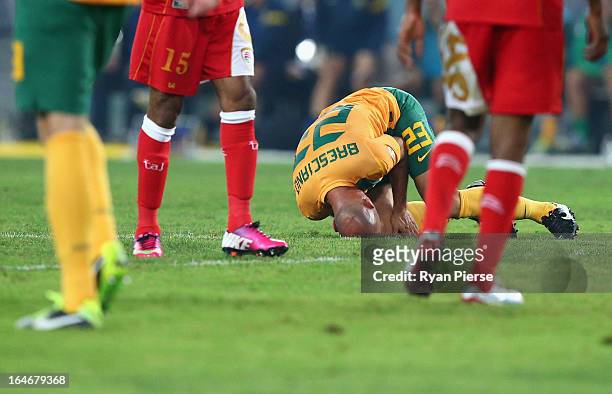 Mark Bresciano of the Socceroos holds his injured knee during the FIFA 2014 World Cup Qualifier match between the Australian Socceroos and Oman at...