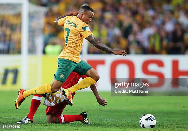 Archie Thompson of the Socceroos gets past Hassan Al Gheilani of Oman during the FIFA 2014 World Cup Qualifier match between the Australian Socceroos...